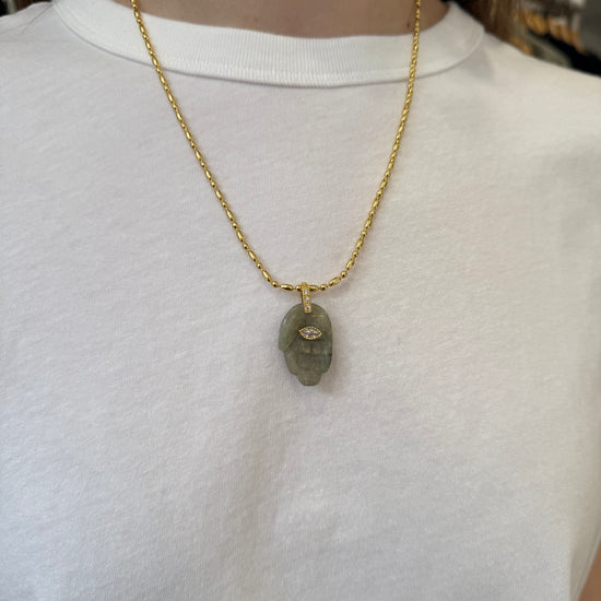 Green hand pendant necklace on a model 