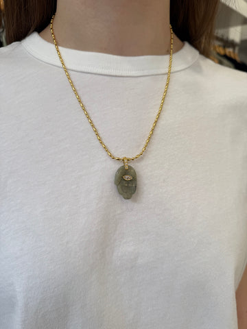 Green hand pendant necklace on a model 