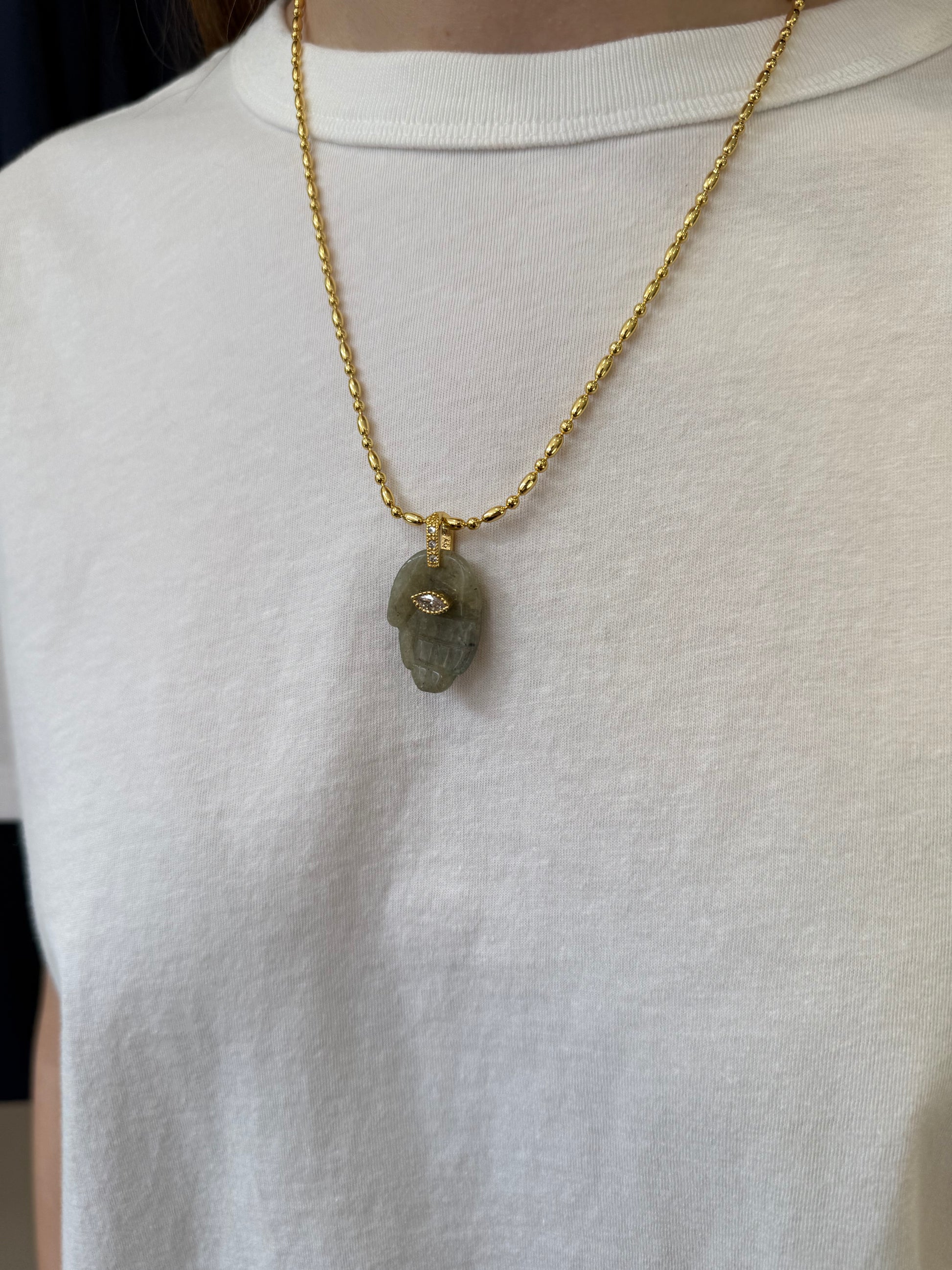 green hand pendant necklace on model 