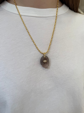 Grey hand pendant ono gold chain on model 