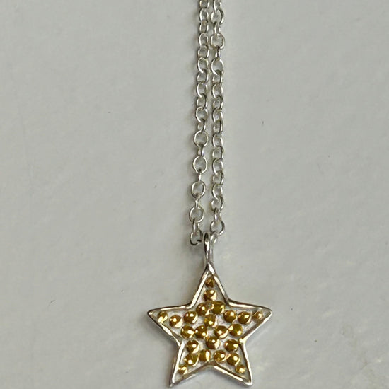 Silver chain with star pendant with small gold dots