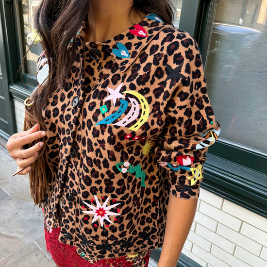 Woman wearing leopard print skirt and skirt with brightly coloured patches on them