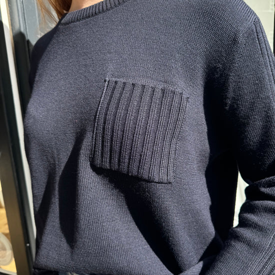 navy merino wool jumper with front patch pocket  close up
