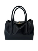 Black shiny leather handbag with shoulder straps and gold buckle detailing.