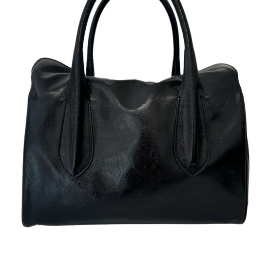 Black shiny leather handbag with shoulder straps and gold buckle detailing.