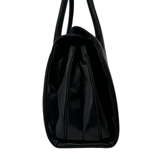 Black shiny leather handbag with shoulder straps and gold buckle detailing.