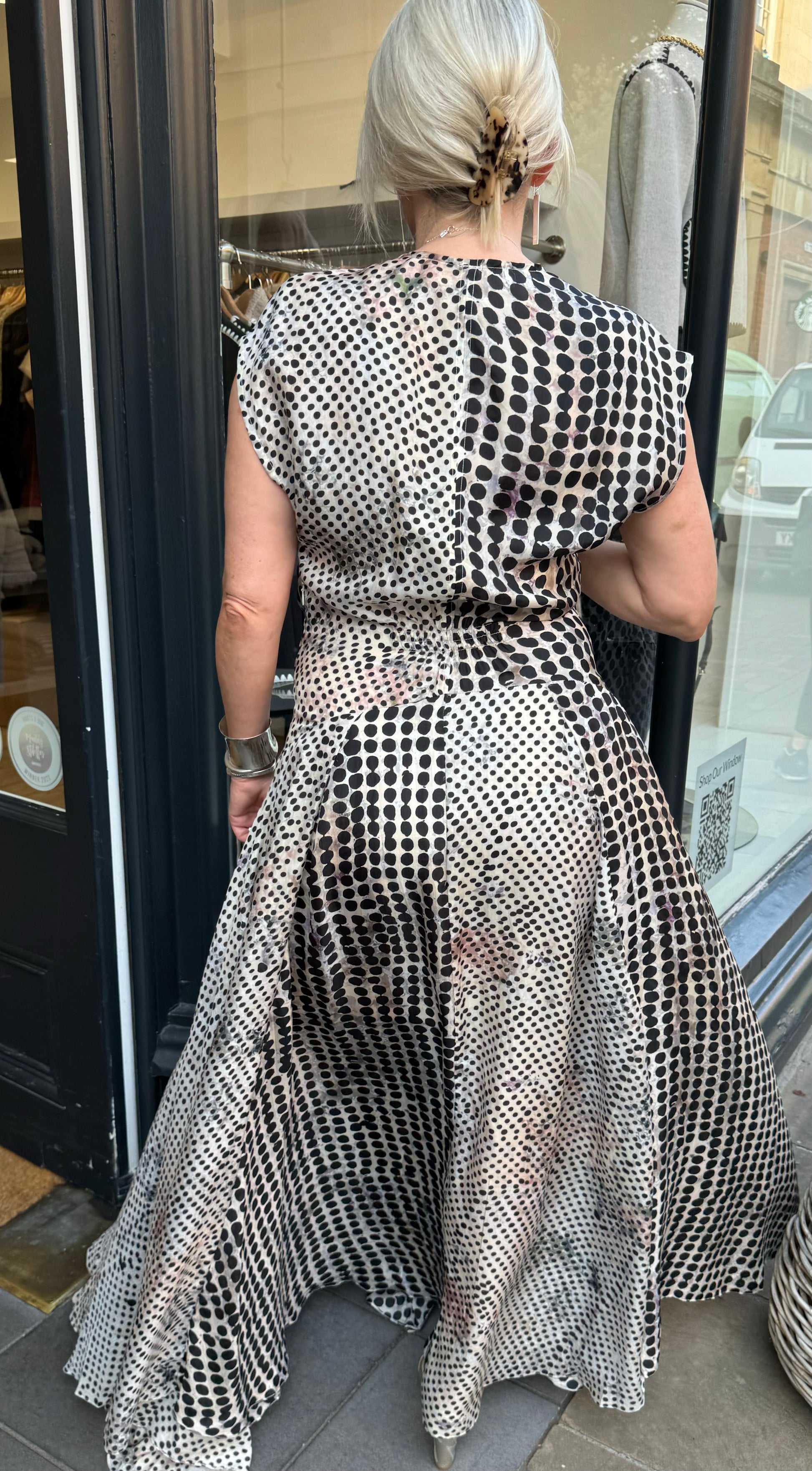 Black and white floaty dress with beautiful silver and gold accessories.