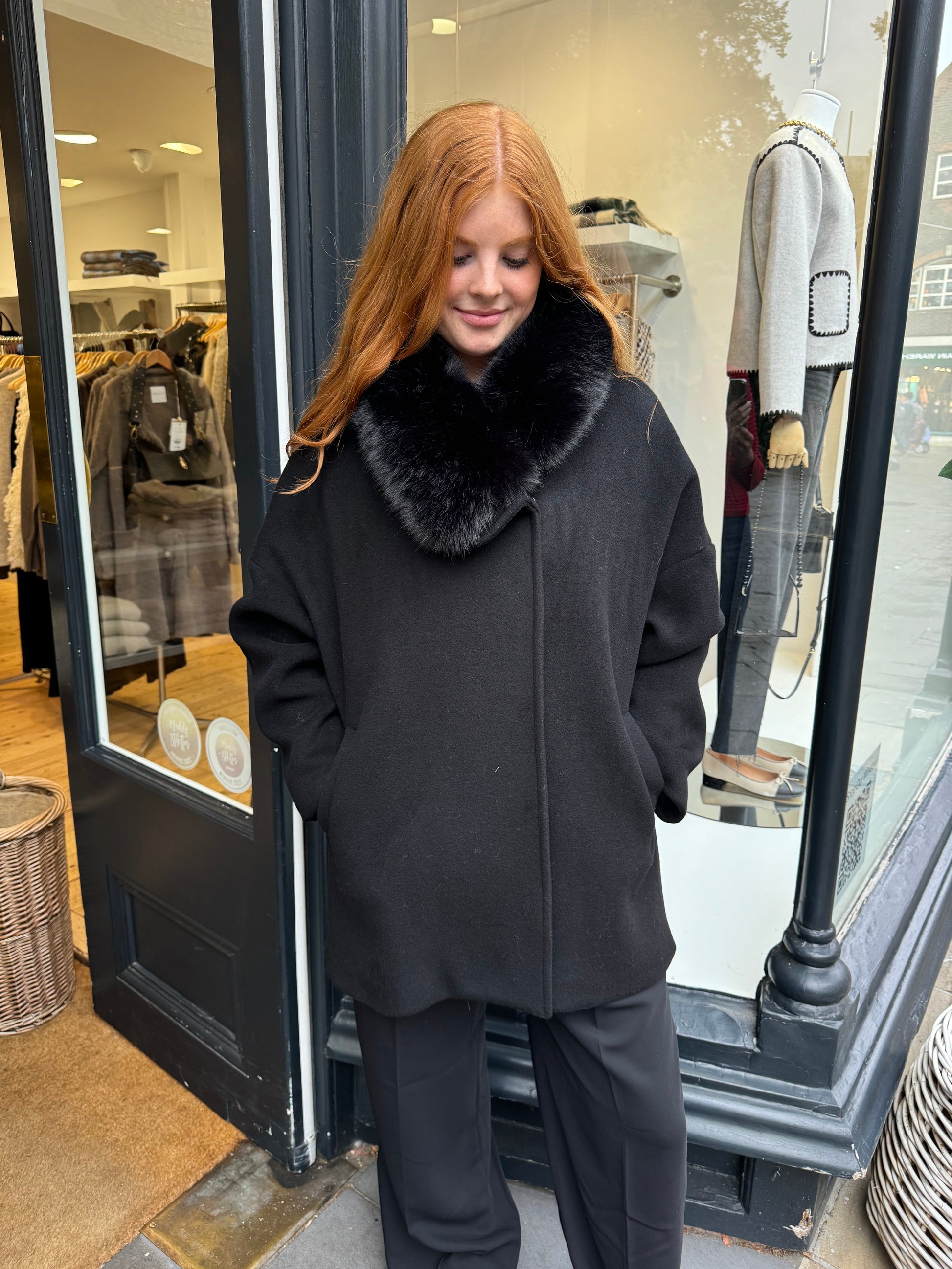 Navy coat with faux fur collar.