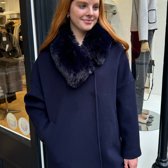 Navy coat with faux fur collar.