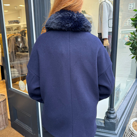 Navy coat with faux fur collar.