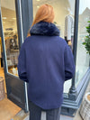 Navy coat with faux fur collar.