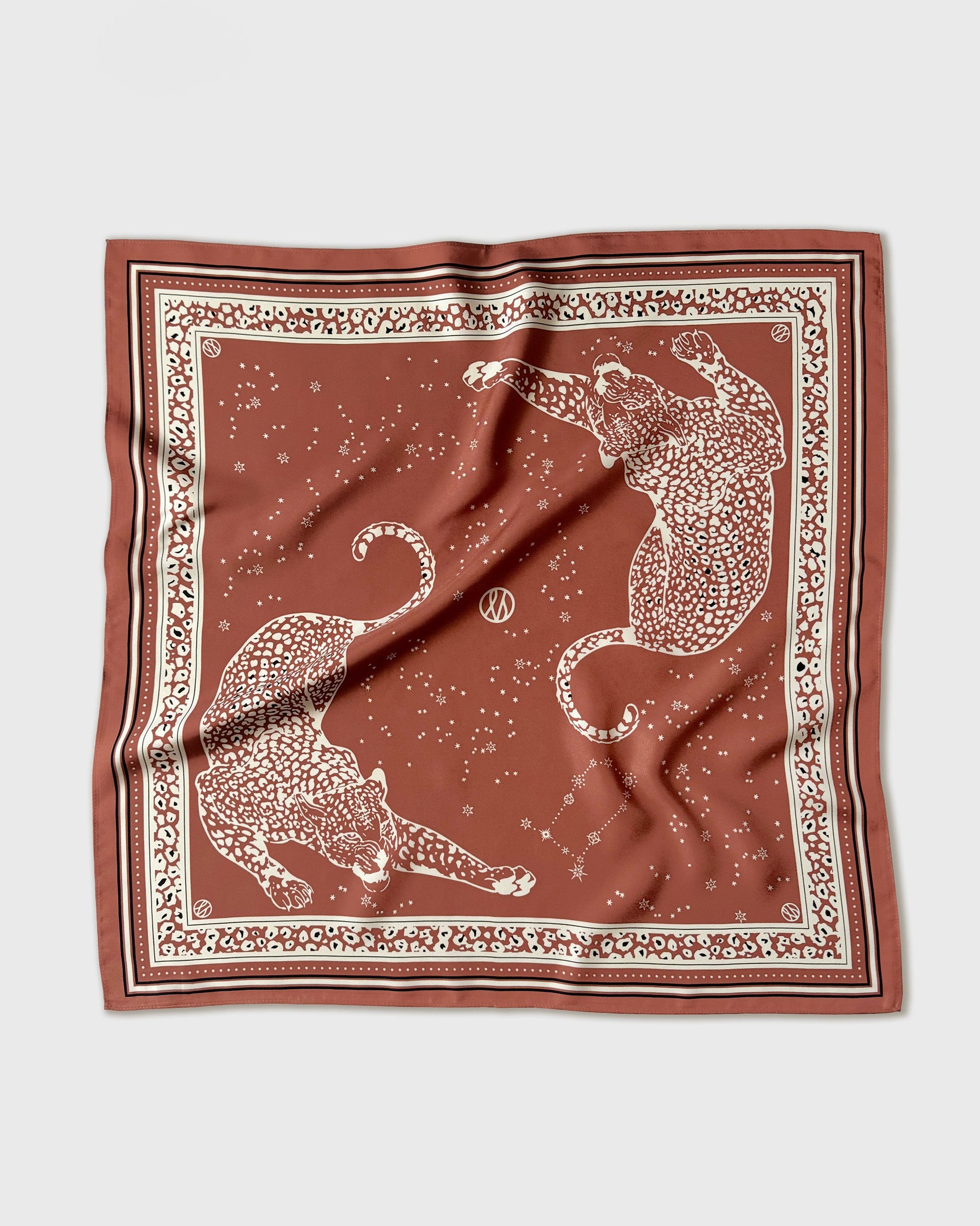 Brown scarf with white animal pattern on a light gray background