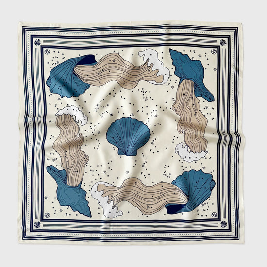 Decorative scarf with blue and beige sea-themed design on a white background