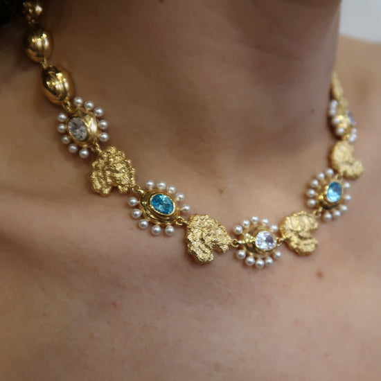 Gold necklace with pearls and blue stones  model shot