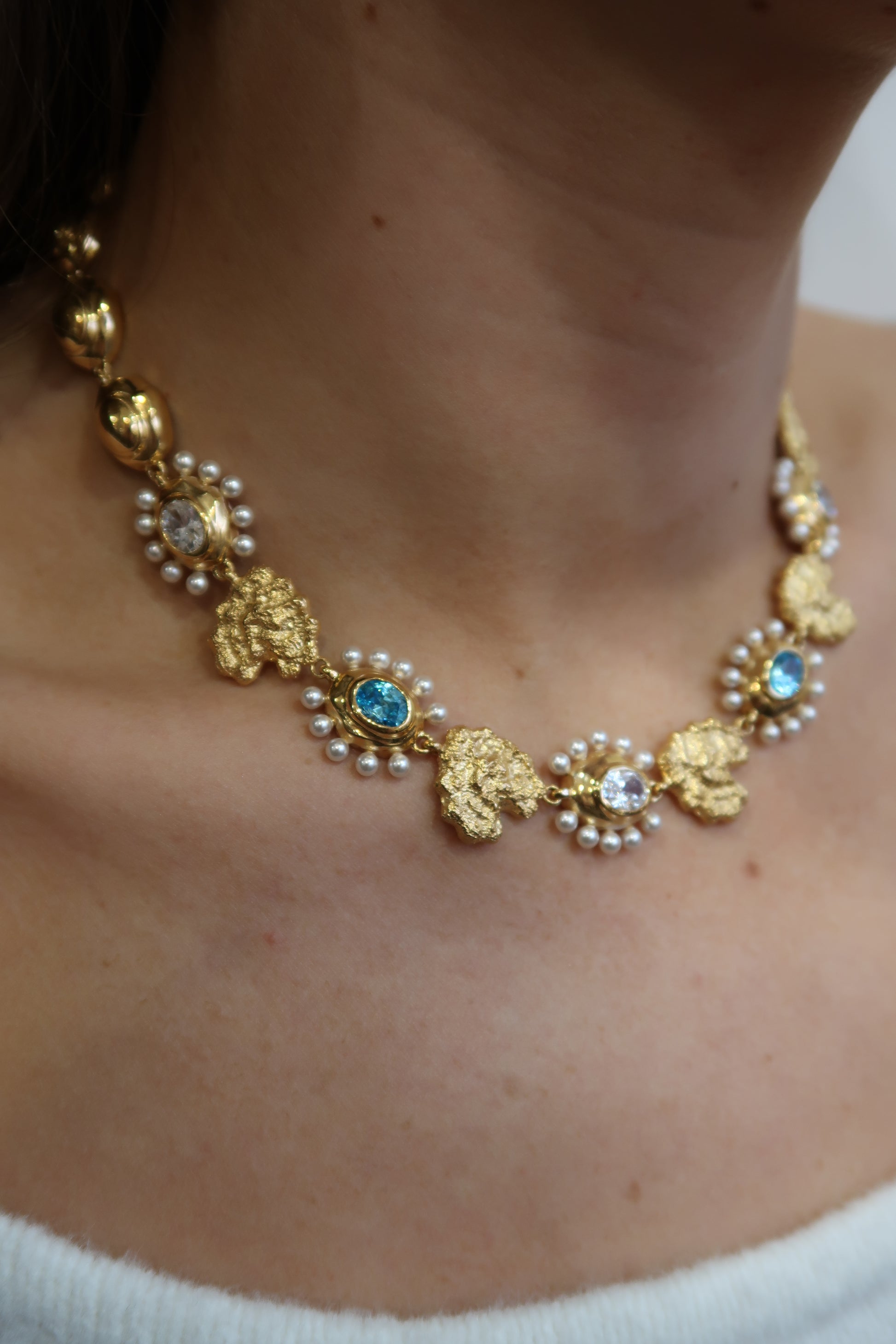 Gold necklace with pearls and blue stones  model shot