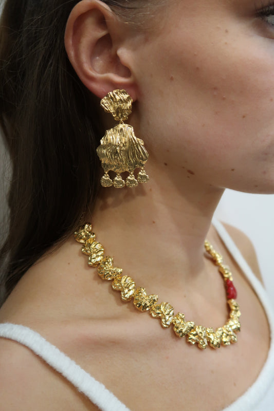 gold petal earrings with larger petal and small charm drops model shot