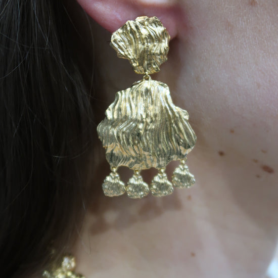 gold petal earrings with larger petal and small charm drops