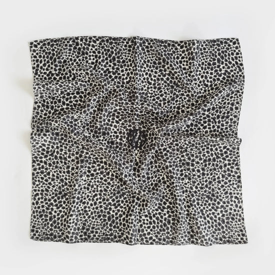 Black and white patterned fabric square on a white background