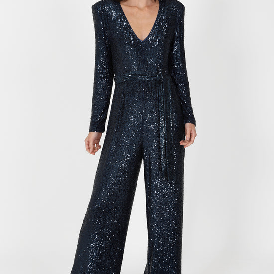 navy sequin jumpsuit with v neck, long sleeves and shoulder pads