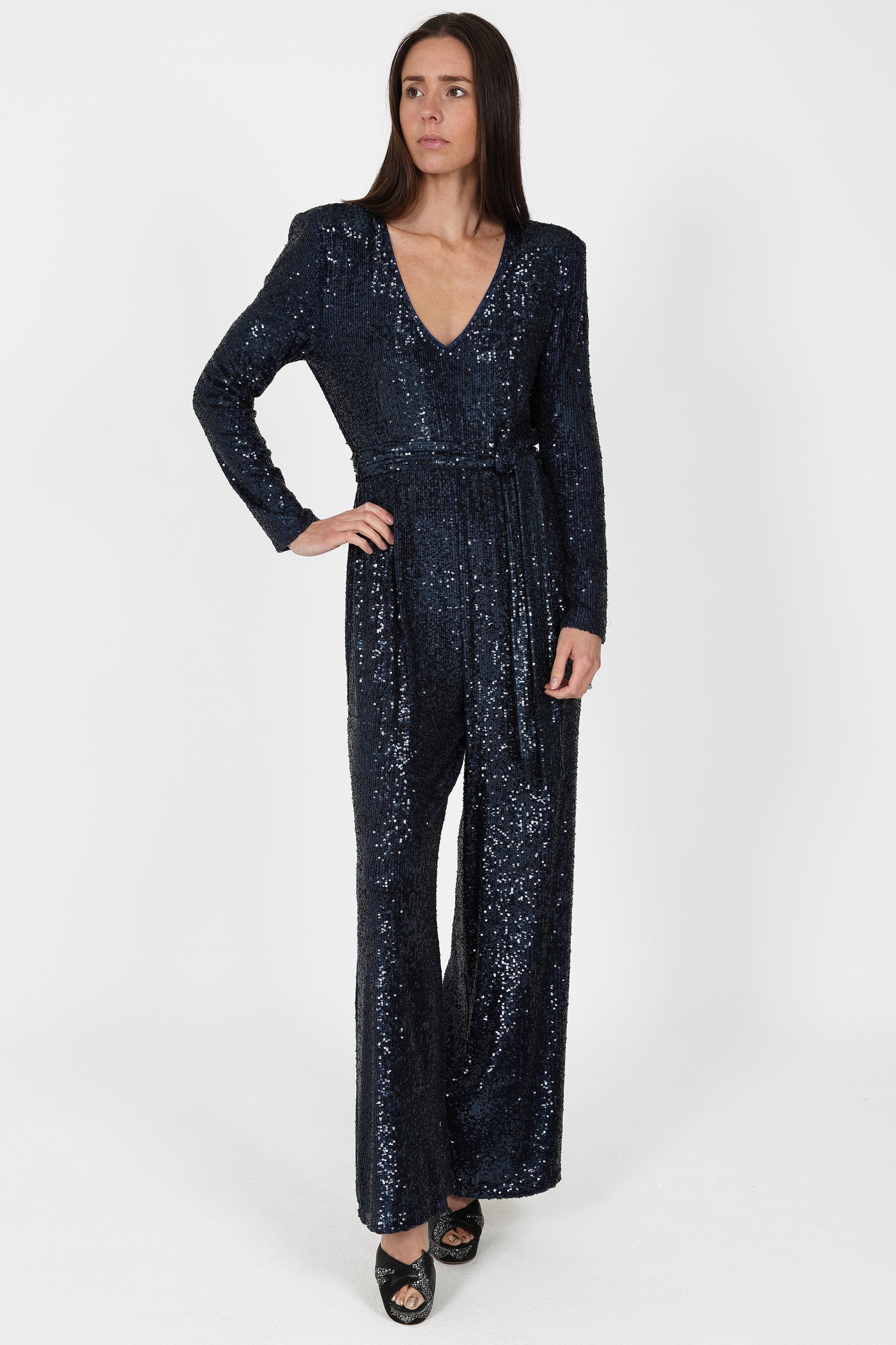 navy sequin jumpsuit with v neck, long sleeves and shoulder pads