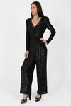 black sequin jumpsuit with v neck and wide leg with shoulder pads