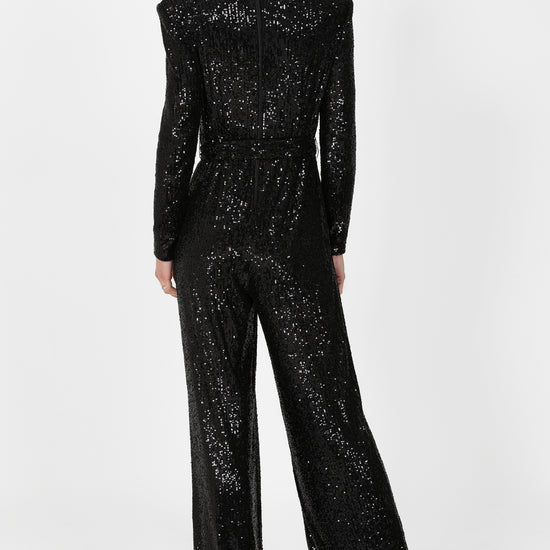 black sequin jumpsuit with v neck and wide leg with shoulder pads rear view 