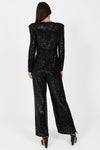 black sequin jumpsuit with v neck and wide leg with shoulder pads rear view 