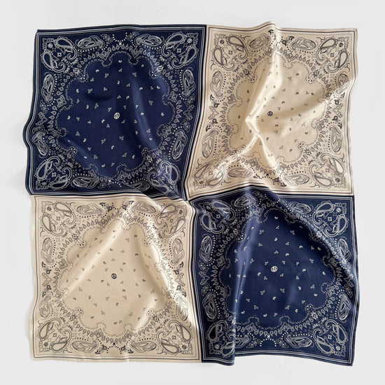 silk scarf with paisley print which has been separated into quarters in navy and beige from lescarf