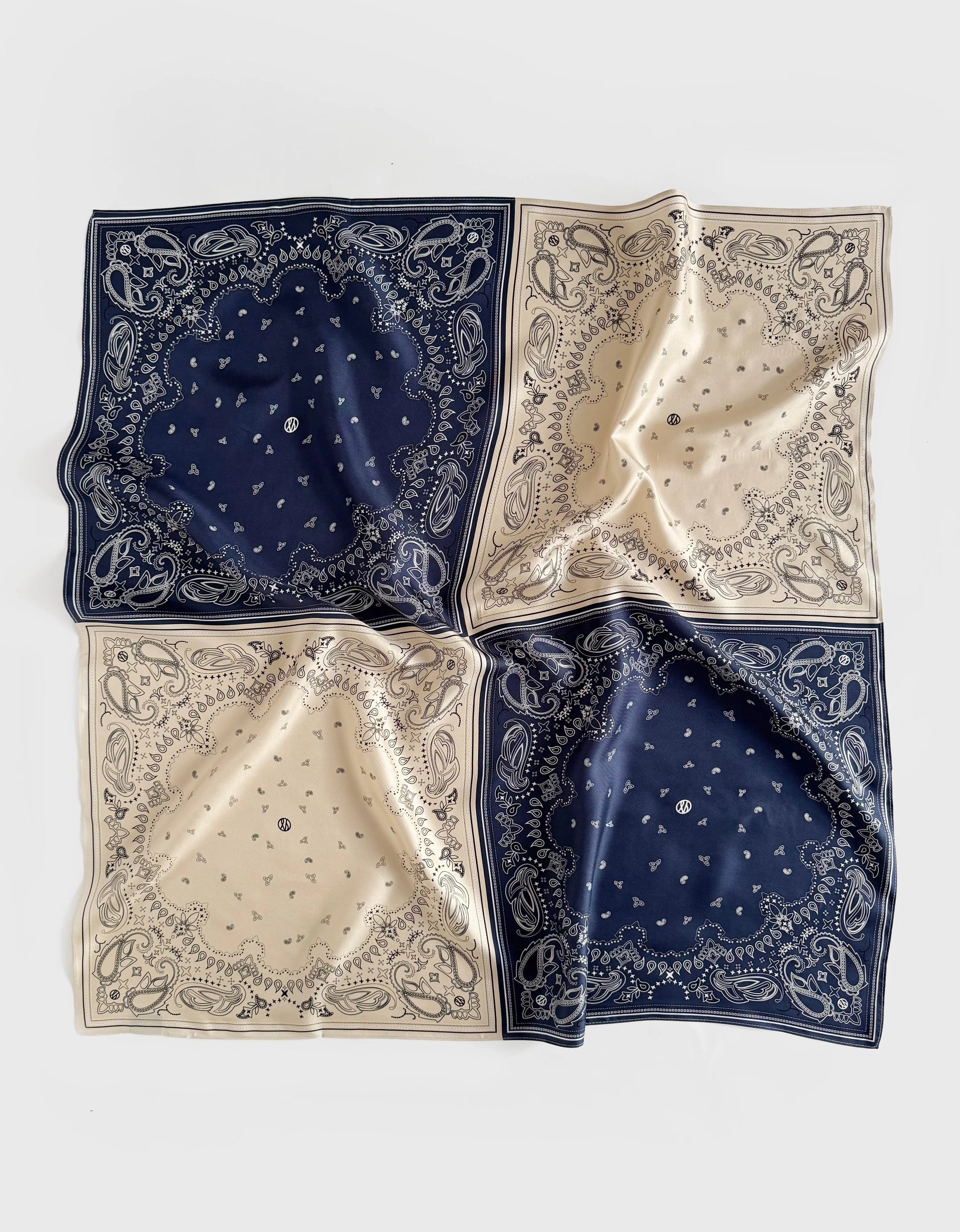 silk scarf with paisley print which has been separated into quarters in navy and beige from lescarf
