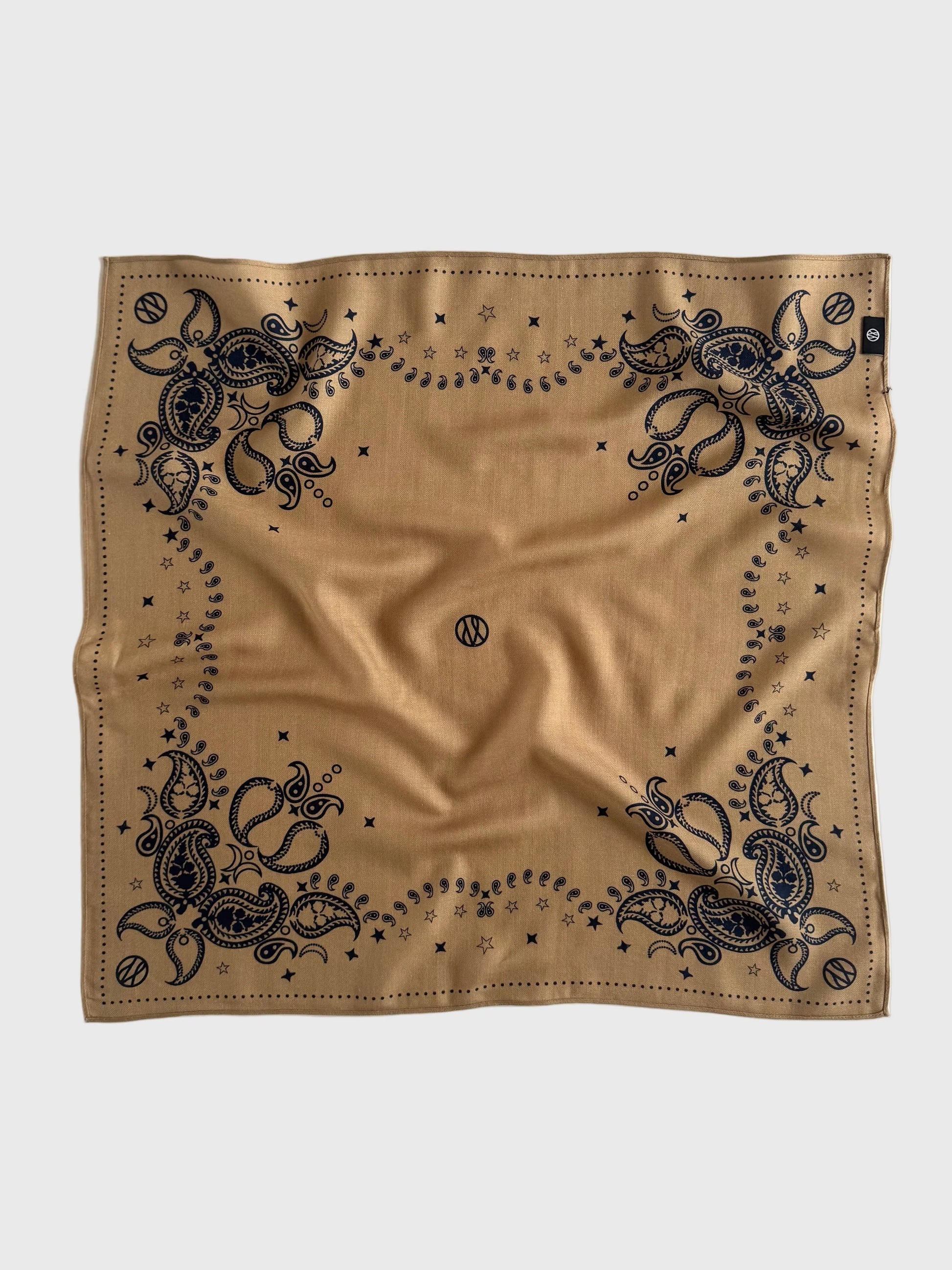 Beige bandana with navy intricate patterns on a white background in a wool silk blend from lescarf