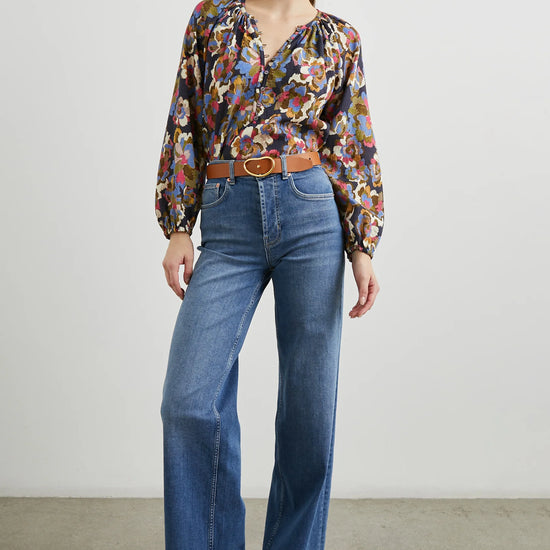 Floral print top with a half button placket and long sleeves with jeans