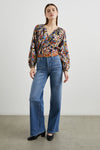 Floral print top with a half button placket and long sleeves with jeans