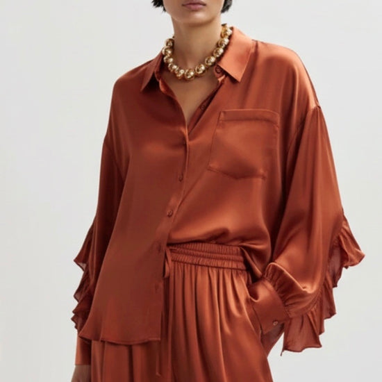 copper satin shirt on a white background