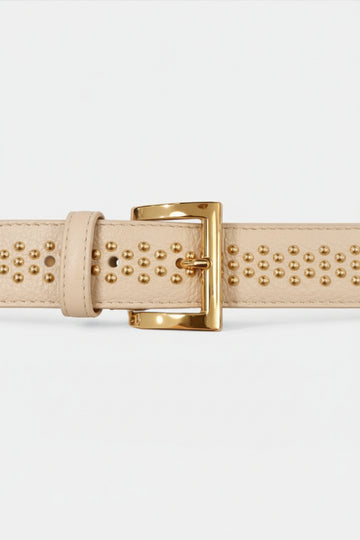 Beige leather belt with gold studs and buckle on a white background
