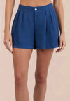 Blue linen shorts worn by a person on a beige background from bella dahl