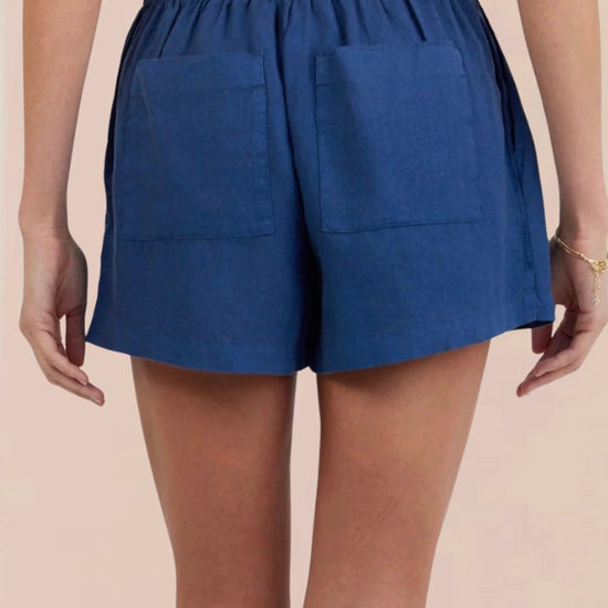 Rear view of Blue shorts worn by a person on a beige background from bella dahl