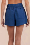 Rear view of Blue shorts worn by a person on a beige background from bella dahl