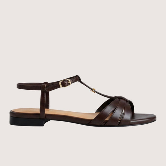 Brown sandal with a thin strap on a light gray background