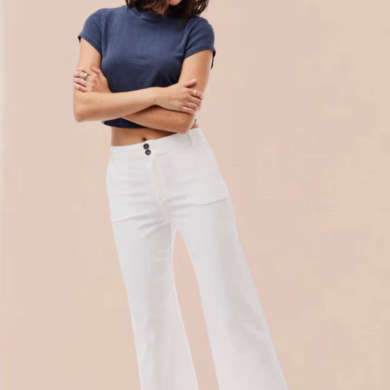 White cropped wide leg trousers with double button and zip fastening with slant side pockets and back patch pockets