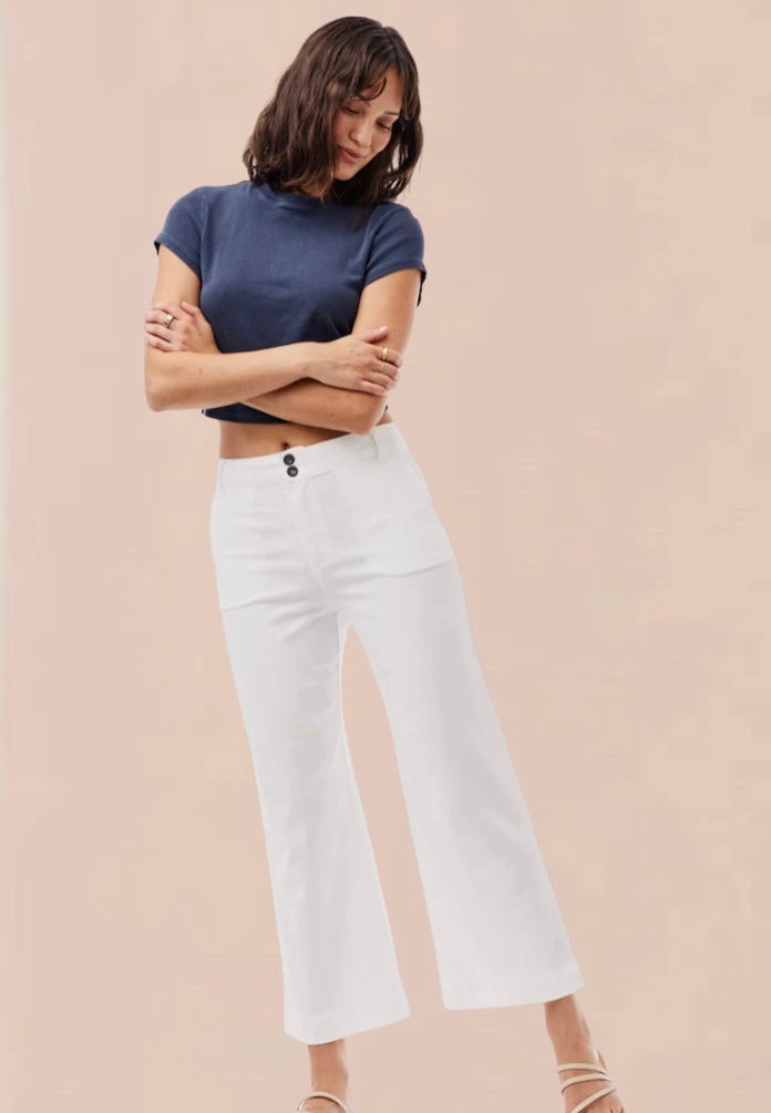 White cropped wide leg trousers with double button and zip fastening with slant side pockets and back patch pockets