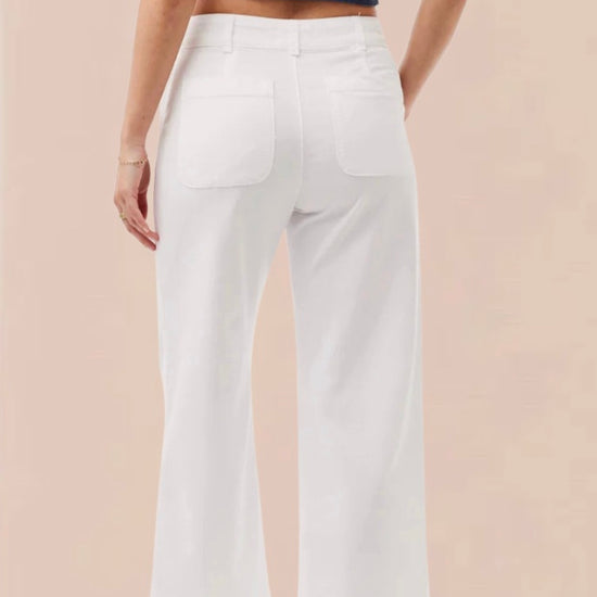 White cropped wide leg trousers with double button and zip fastening with slant side pockets and back patch pockets