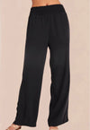 A pair of vintage black smocked waist trousers with wide-leg shape, side pockets, and an elasticated waistband.