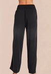 A pair of vintage black smocked waist trousers with wide-leg shape, side pockets, and an elasticated waistband.
