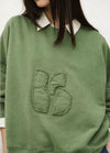 stylish slouchy forest green sweatshirt with bash detail on the front 
