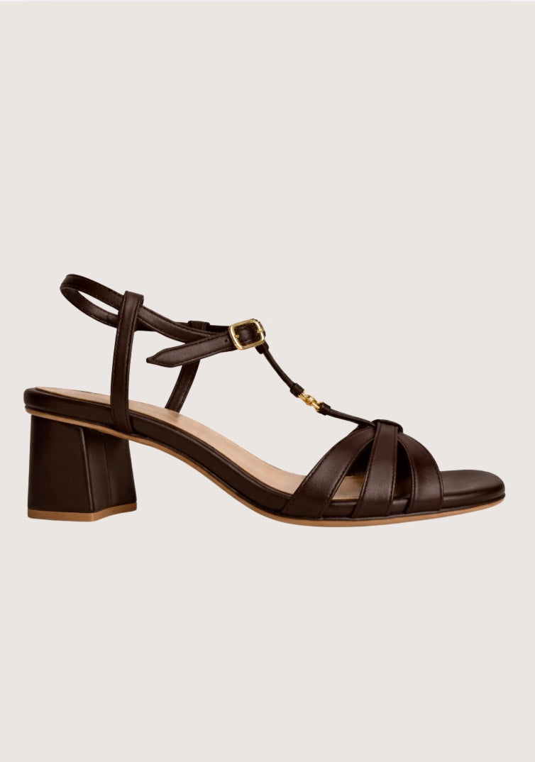 Brown leather sandal with a block heel on a light gray background