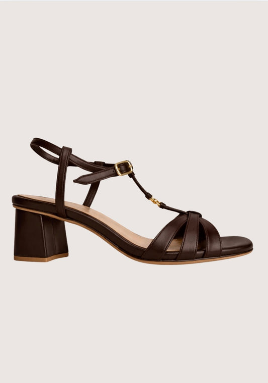Brown leather sandal with a block heel on a light gray background