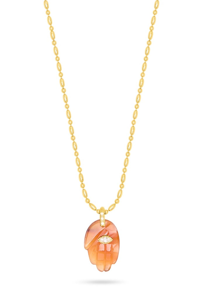 textured gold chain with protective hand pendent in a red quartz colour