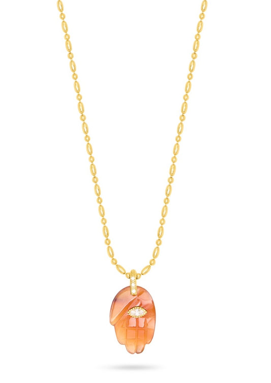 textured gold chain with protective hand pendent in a red quartz colour