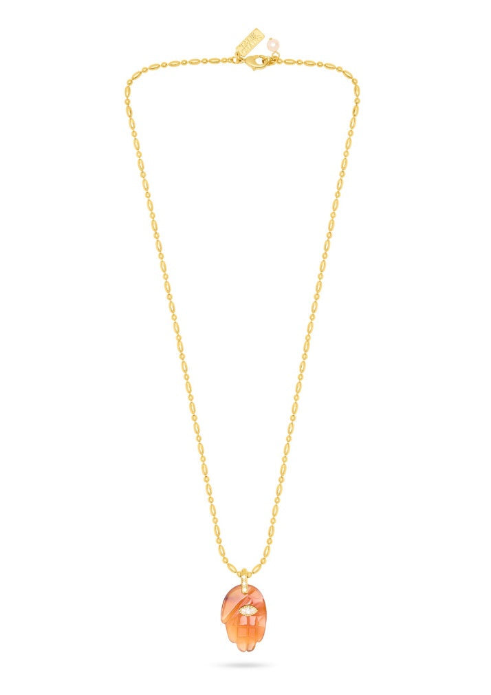 textured gold chain with protective hand pendent in a red quartz colour