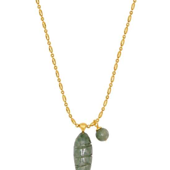 chunky gold chain with a green fish pendant